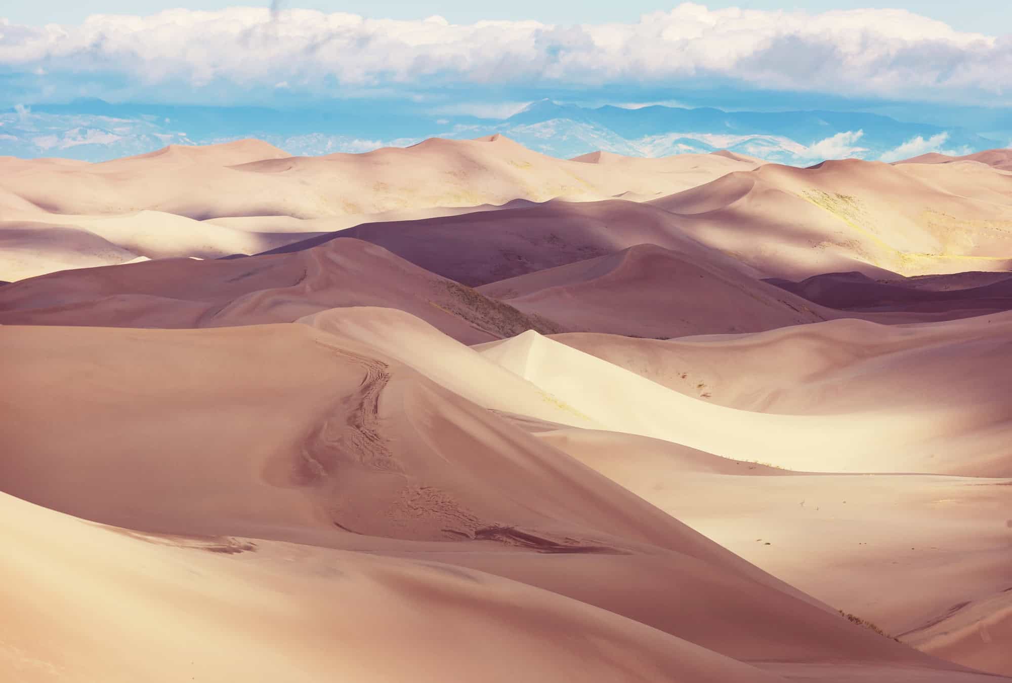 Clouds over mountains of sand photographed at Great Sand Dunes National Park, Colorado