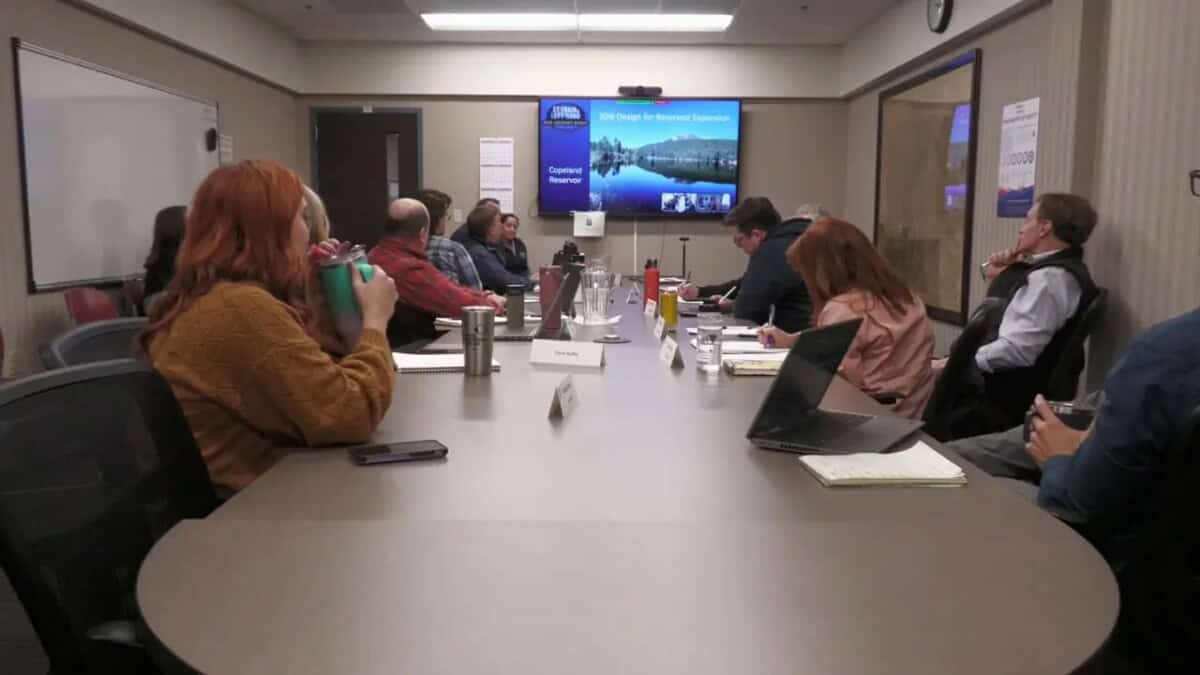 Water advisory board meeting with slide titled 'Copeland Reservoir' and reservoir expansion imagery on the screen
