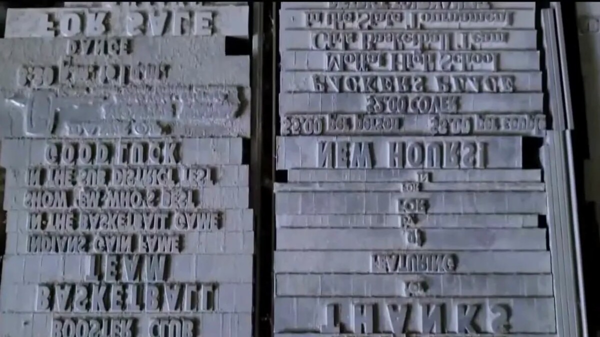 Close view of a metal plate labeled Linotype model information